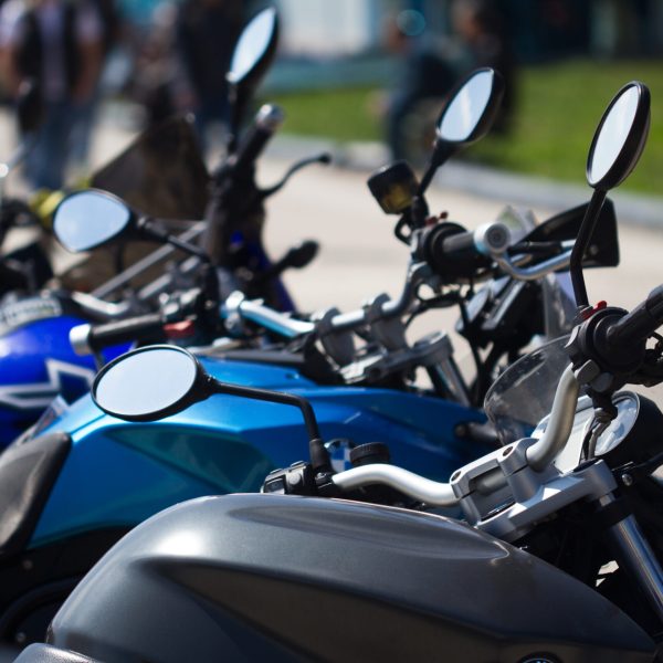 vertical detail row of parked motorcycles in the street selective focus